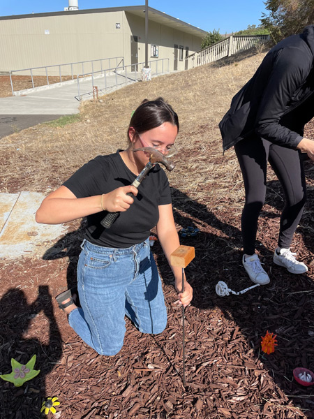 14_student-putting-flower-together-outdoors