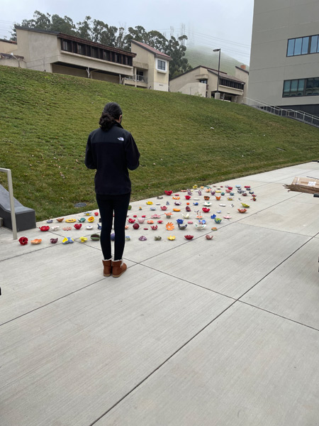 5.2_student-in-front-of-collection-of-flowers