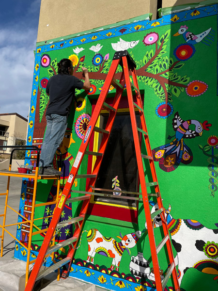 9_student-painting-on-colorful-wall